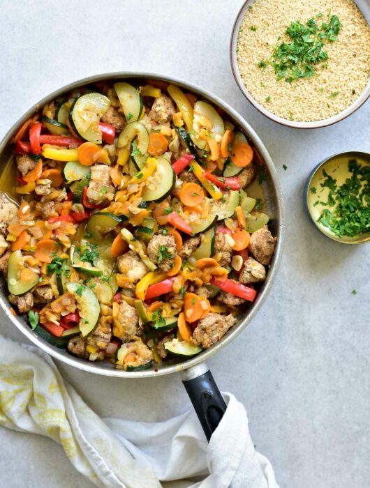 moroccan chicken with apricots and vegetables in a pan