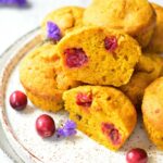 pumpkin muffins with fresh cranberries on a white plate