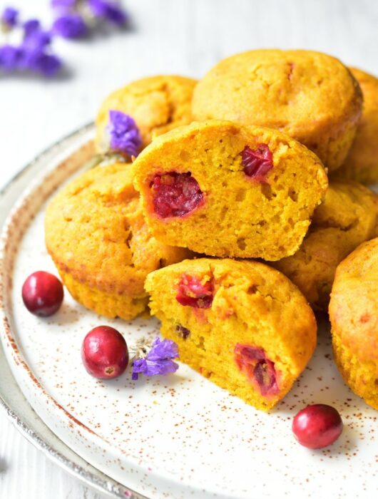pumpkin muffins with fresh cranberries on a white plate