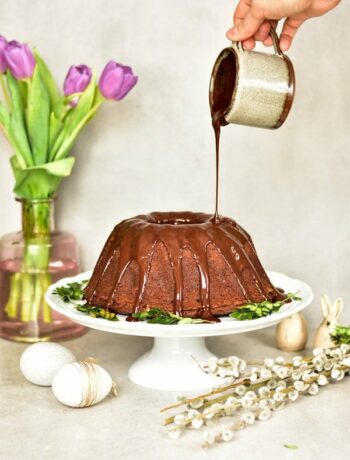 chocolate orange bundt cake on a white cake stand