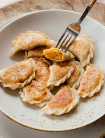 vegan pierogi with lentil and sun-dried tomato filing on a light brown plate