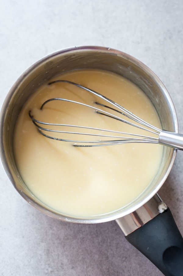 melten white chocolate with sour cream and butter in a pot