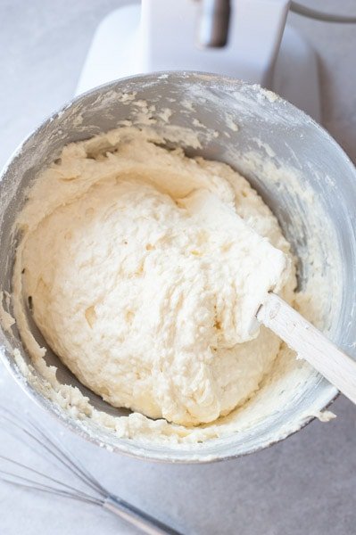 coconut cake with strawberries batter in a mixer bowl