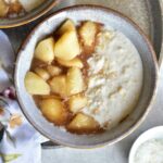 coconut oatmeal with syrupy pears in a grey bowl