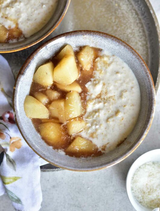 coconut oatmeal with syrupy pears in a grey bowl