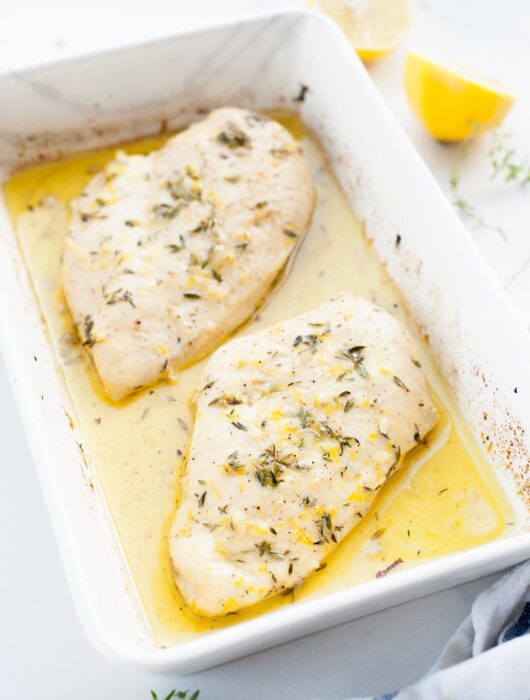 lemon thyme chicken in a white baking dish