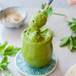 green tahini sauce in a jar