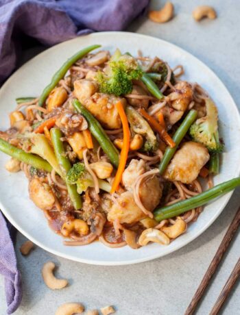 chinese plum sauce noodles with chicken and vegetables on a white plate