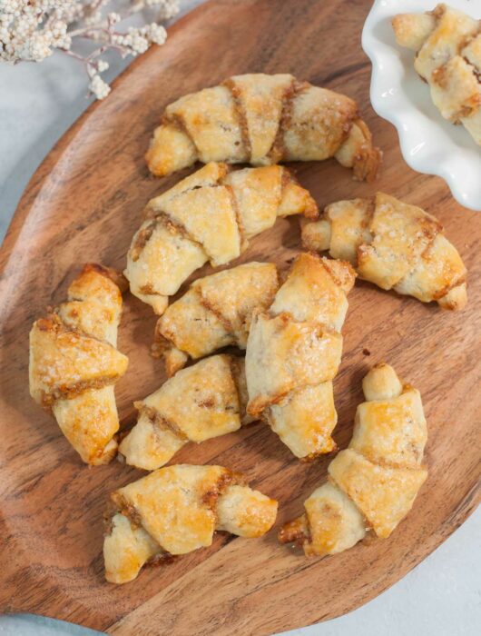 Rogaliki cookies on a chopping board.