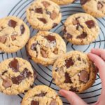 Chocolate chunk peanut butter cookie held in a hand.