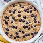 Banana blueberry baked oatmeal in a white baking dish.