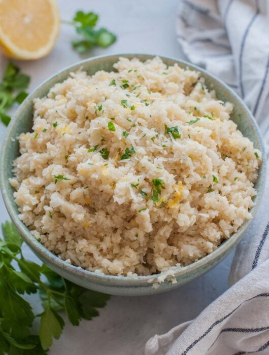 Parmesan cauliflower rice in a green bowl.