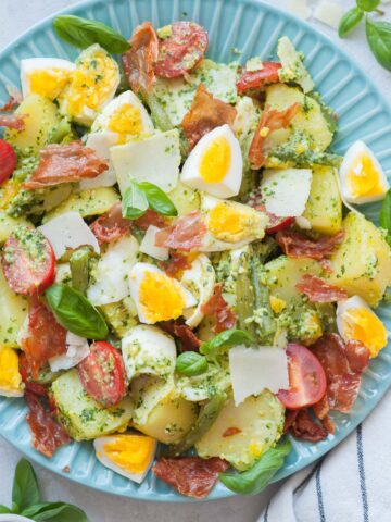 Pesto potato salad on a blue plate.