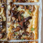 A close up photo of puff pastry mushroom tart.