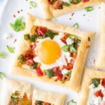 Puff pastry breakfast tarts on a white plate.