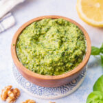 Basil walnut pesto in a brown bowl.