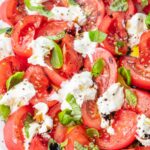 Burrata Caprese salad on a white plate.