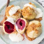 Polish plum dumplings on a green plate.