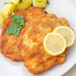 German pork Schnitzel on a beige plate.