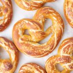 Soft pretzels on a piece of parchment paper.