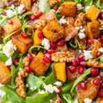 Toasted butternut squash salad on a white plate.