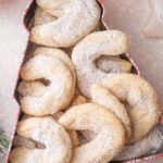 Vanillekipferl cookies in a cookie tin.