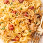 Austrian cabbage and noodles with Speck (Krautflecker) on a beige plate.