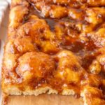 A close-up photo of Brunsviger cake on a wooden board.