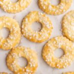 Saure-Sahne-Kringel cookies on a marble counter.